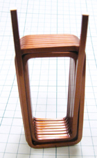 A rectangular edgewise coil made of a rectangular copper wire wound and folded to form two layers.