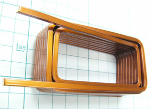 A rectangular edgewise coil made of a rectangular copper wire wound and folded to form two layers.