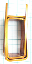 A rectangular edgewise coil made of a rectangular copper wire wound and folded to form two layers.