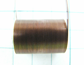 A thin (0.2 mm) and wide (2.5 mm) edgewise coil (wound upright). 