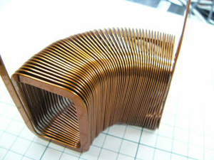 No spring-back effect. This coil has the feature of no bulging (bulge from winding) of the straight part and less inside bulging of the bent part (bulge from bending). It is versatile in forming a trapezoidal shape etc.